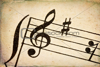 treble clef on vintage music sheet