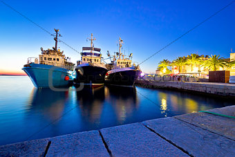 Fishing boats in harbor evening view