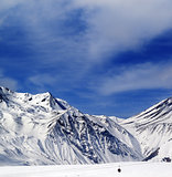 Winter mountains and blue sky with clouds