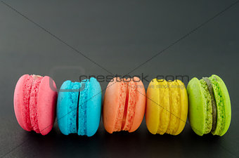 Row of french colorful macaroons.