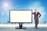 Businessman leaning on monitor