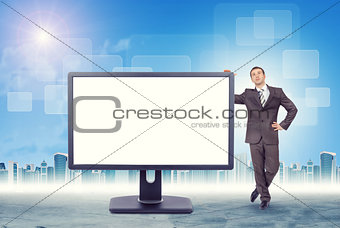 Businessman leaning on monitor