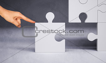 Man hand pushing puzzle piece