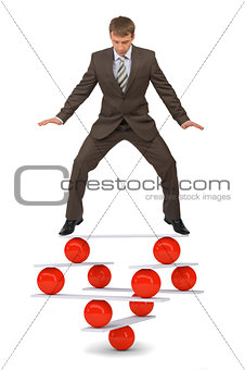 Businessman on balance balls