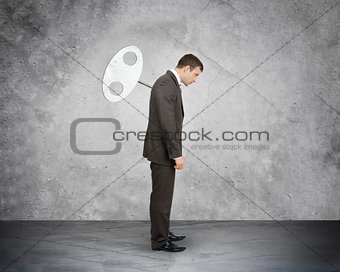 Businessman with key in back looking down