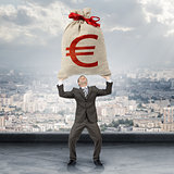 Businessman holding big moneybag with euro sign
