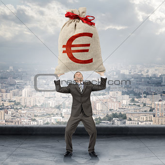 Businessman holding big moneybag with euro sign