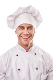 standing smiling male cook in white uniform and hat