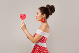 Happy Woman Holding red Lollipop Shape of Heart. Pin-up retro style.