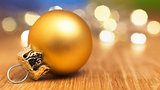 golden bauble with bokeh lights