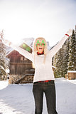 Woman in a funny Christmas glasses in front of a mountain house