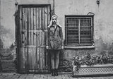 Girl in coat standing near the wall