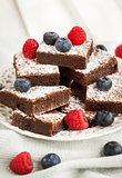 Chocolate brownies decorated with fresh berries
