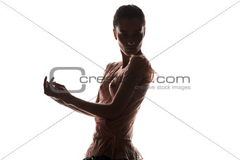 A silhouette of a woman in transparent blouse