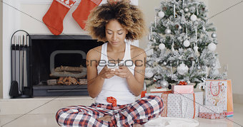 Young woman sending a Christmas message