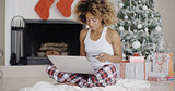 Young woman shopping online for Christmas