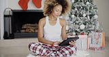 Thoughtful woman catching up on Christmas news