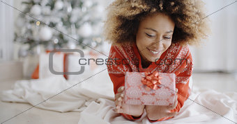 Thoughtful young woman with a Christmas gift