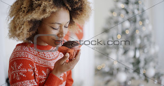 Young woman savoring a Christmas cake