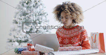 Young woman using a laptop at Christmas