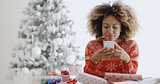 Young African woman checking for Xmas messages