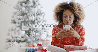 Young African woman checking for Xmas messages