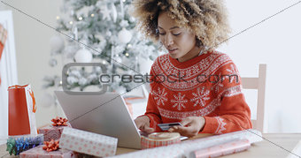 Young woman doing Xmas shopping online