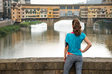 Fitness female in sportswear looking on Ponte Vecchio