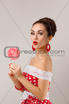 Funny Woman Holding Two Red Lollipops. Pin-up retro style.