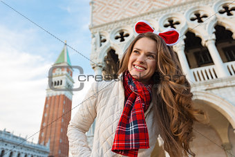 Happy woman tourist spending Christmas holidays in Venice, Italy