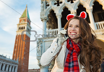 Woman talking smartphone while on Christmas in Venice, Italy