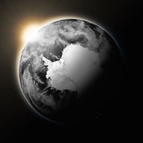 Sun over Antarctica on dark planet Earth