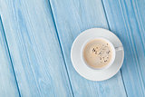 Coffee cup on wooden table background