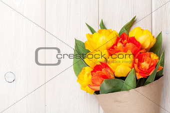 Colorful tulips over wooden table