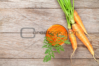 Fresh carrot juice smoothie and roots