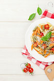 Colorful penne pasta with tomatoes and basil