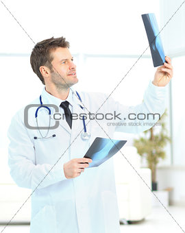 young doctor consider x-ray photos