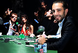 young people are playing poker in a casino