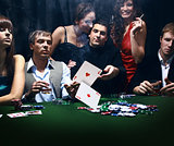 young people are playing poker in a casino