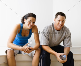 Male and female sitting smiling.