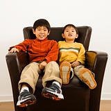 Asian brothers in chair