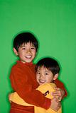 Asian brothers hugging