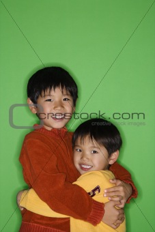 Asian brothers hugging
