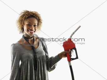 Woman holding fuel pump nozzle