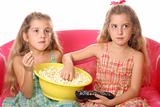 shot of children eating popcorn watching tv