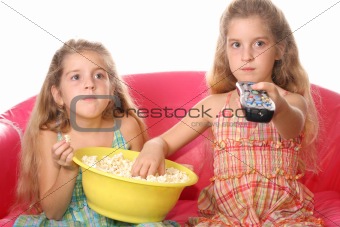 shot of children watching a movie eating popcorn