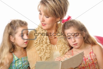 shot of a Gorgeous woman reading to her Grandchildren
