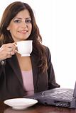 shot of a beautiful woman working on computer having tea