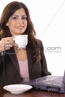 shot of a beautiful woman working on computer having tea