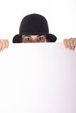 shot of a woman in hat peeking over blank copyspace vertical
